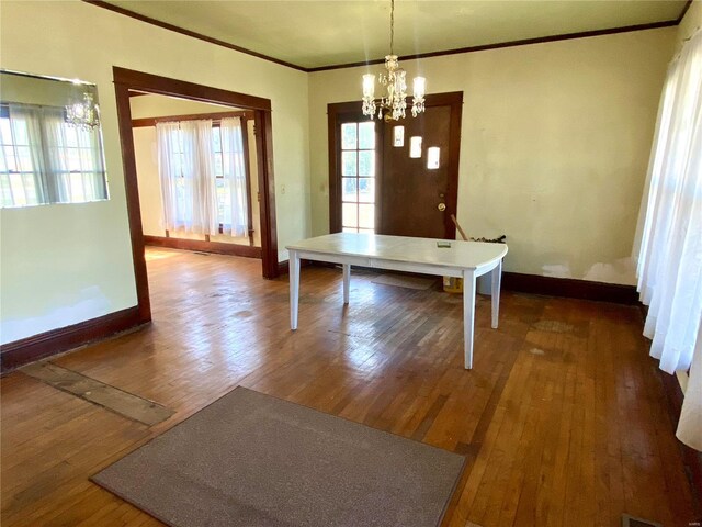 101 E Cedar St, Bertrand, MO 63823 - unfurnished dining area featuring a chandelier, ornamental molding, wood-type flooring, and baseboards