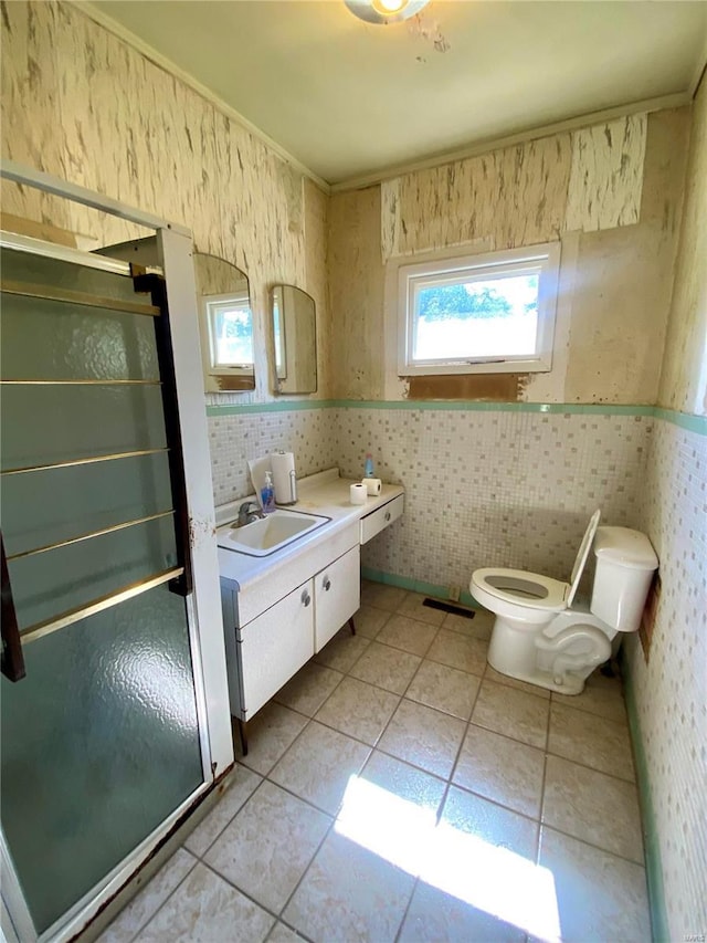 101 E Cedar St, Bertrand, MO 63823 - bathroom featuring a shower stall, wallpapered walls, toilet, tile patterned flooring, and vanity