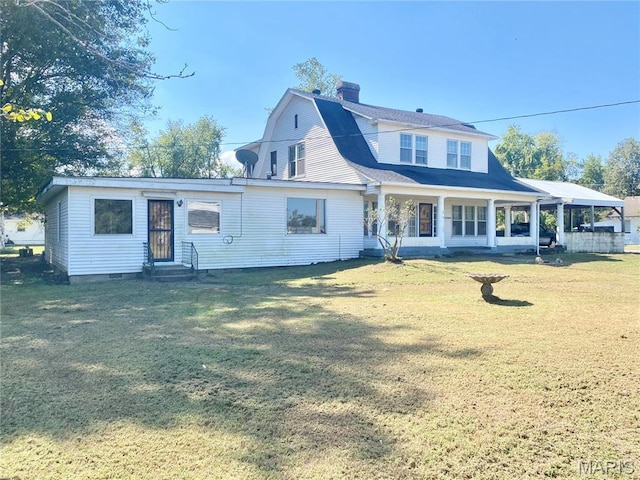 101 E Cedar St, Bertrand, MO 63823 - rear view of property featuring entry steps, a yard, a gambrel roof, and a chimney