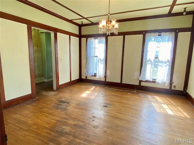 101 E Cedar St, Bertrand, MO 63823 - unfurnished room with healthy amount of natural light, a chandelier, and hardwood / wood-style floors