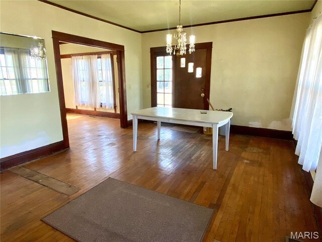 101 E Cedar St, Bertrand, MO 63823 - unfurnished dining area featuring a chandelier, crown molding, and dark wood-style floors