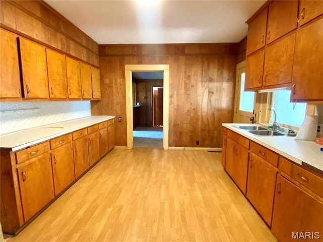 101 E Cedar St, Bertrand, MO 63823 - kitchen featuring light wood-style flooring, brown cabinetry, light countertops, and wood walls