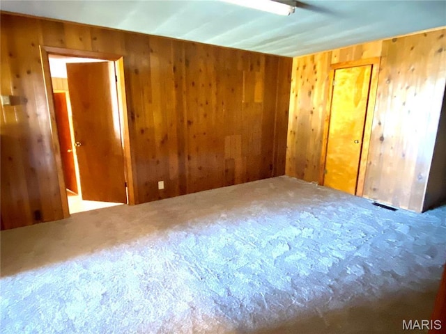101 E Cedar St, Bertrand, MO 63823 - carpeted spare room with wood walls