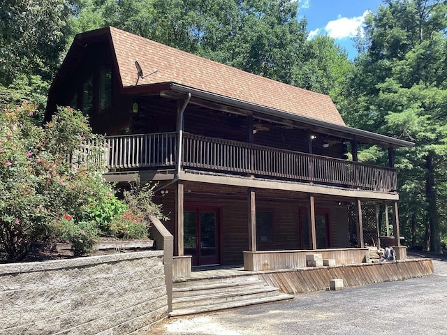 1102 County Road 5, Rockwood, IL 62280 - view of front of property with log exterior, a shingled roof, a wooden deck, and a porch