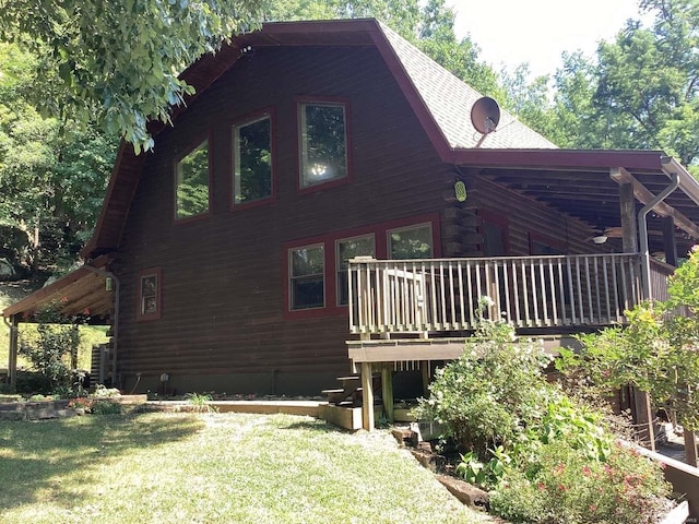 1102 County Road 5, Rockwood, IL 62280 - view of property exterior with log siding, a lawn, a wooden deck, and a shingled roof