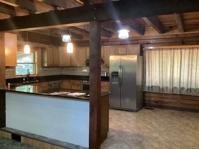 1102 County Road 5, Rockwood, IL 62280 - kitchen with stainless steel fridge, dark countertops, a sink, a peninsula, and decorative light fixtures