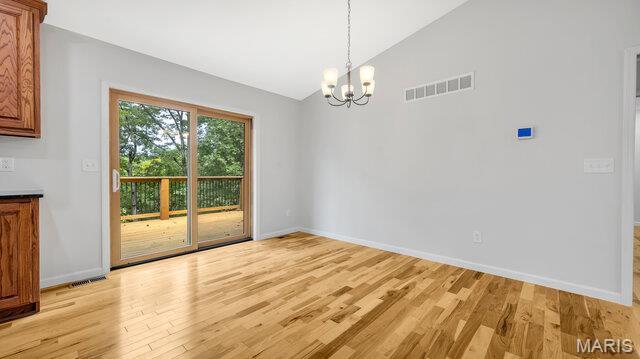 18305 Joerling Ln, Marthasville, MO 63357 - unfurnished dining area with light wood-style floors, a chandelier, baseboards, and high vaulted ceiling