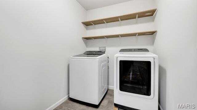 18305 Joerling Ln, Marthasville, MO 63357 - laundry room with washing machine and clothes dryer and baseboards