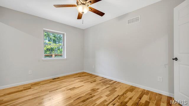 18305 Joerling Ln, Marthasville, MO 63357 - spare room featuring light wood finished floors, ceiling fan, and baseboards