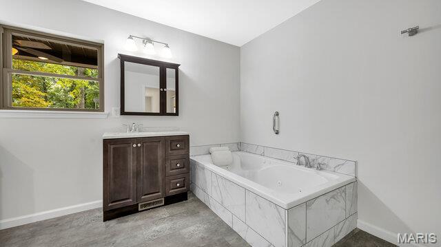 18305 Joerling Ln, Marthasville, MO 63357 - full bathroom featuring a jetted tub, vanity, and baseboards