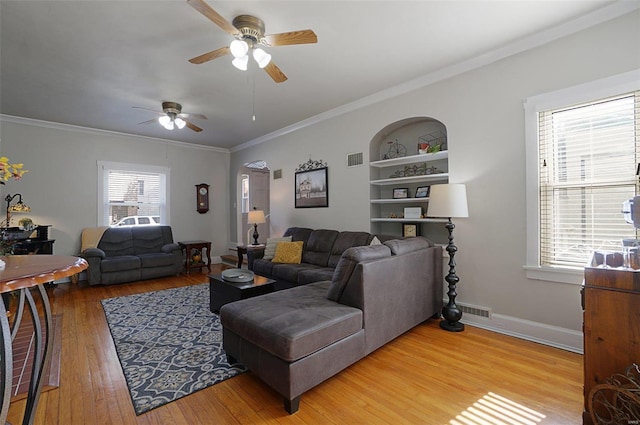 401 Elm St, Washington, MO 63090 - living room featuring a ceiling fan, light wood finished floors, crown molding, built in shelves, and baseboards