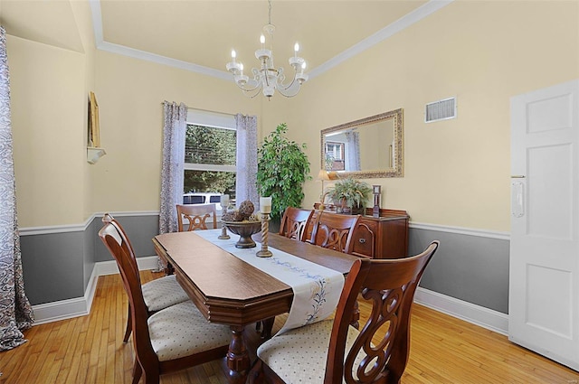 401 Elm St, Washington, MO 63090 - dining room featuring a chandelier, light wood-type flooring, crown molding, and baseboards