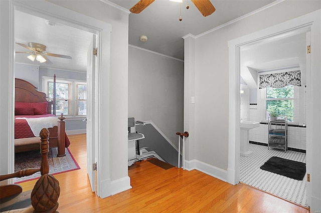 401 Elm St, Washington, MO 63090 - hallway featuring light wood-type flooring, baseboards, an upstairs landing, and crown molding