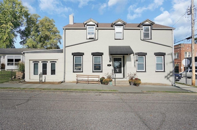 401 Elm St, Washington, MO 63090 - townhome / multi-family property featuring a chimney, entry steps, and brick siding