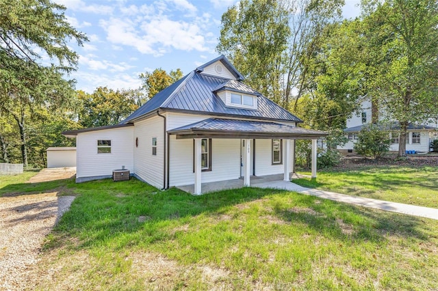 105 N Coffman St, Park Hills, MO 63601 - back of property with metal roof, a lawn, central AC, and a porch