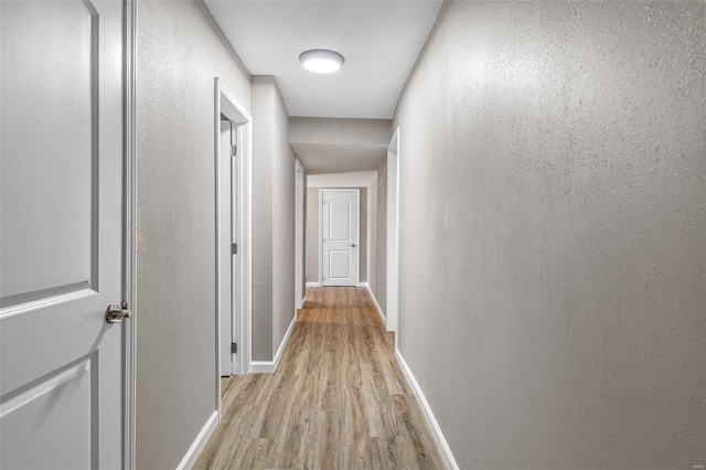 105 N Coffman St, Park Hills, MO 63601 - hall featuring light wood-style floors, baseboards, and a textured wall
