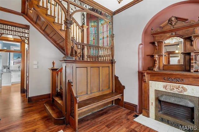 2712 S Compton Ave, Saint Louis, MO 63118 - staircase featuring wood finished floors, baseboards, and crown molding