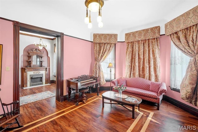 2712 S Compton Ave, Saint Louis, MO 63118 - living room with a chandelier, wood finished floors, a fireplace, and baseboards