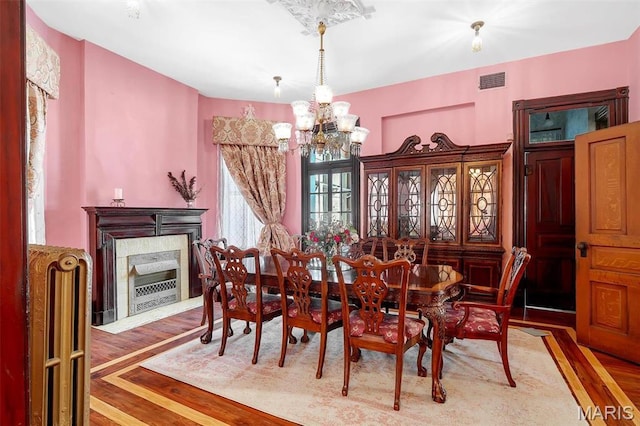 2712 S Compton Ave, Saint Louis, MO 63118 - dining room featuring a chandelier and wood finished floors
