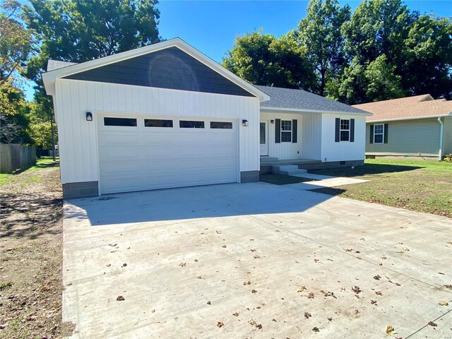 317 E Cypress St, Charleston, MO 63834 - ranch-style home with concrete driveway, an attached garage, and a shingled roof