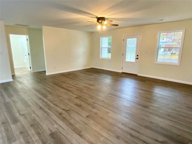 317 E Cypress St, Charleston, MO 63834 - unfurnished living room with ceiling fan, wood finished floors, and baseboards