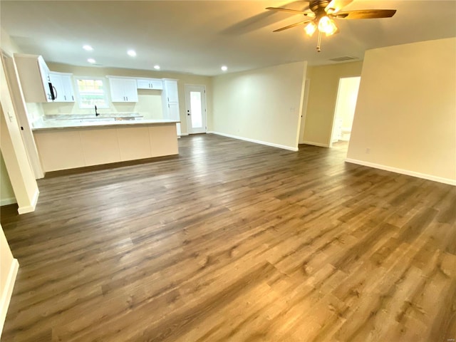317 E Cypress St, Charleston, MO 63834 - unfurnished living room featuring a ceiling fan, recessed lighting, baseboards, and dark wood finished floors