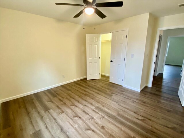 317 E Cypress St, Charleston, MO 63834 - unfurnished bedroom with wood finished floors, baseboards, and ceiling fan
