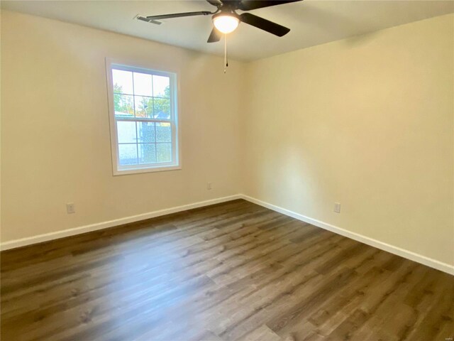 317 E Cypress St, Charleston, MO 63834 - unfurnished room featuring ceiling fan, dark wood-style floors, and baseboards