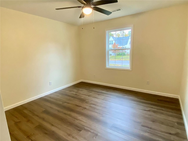 317 E Cypress St, Charleston, MO 63834 - empty room featuring dark wood-type flooring, ceiling fan, and baseboards