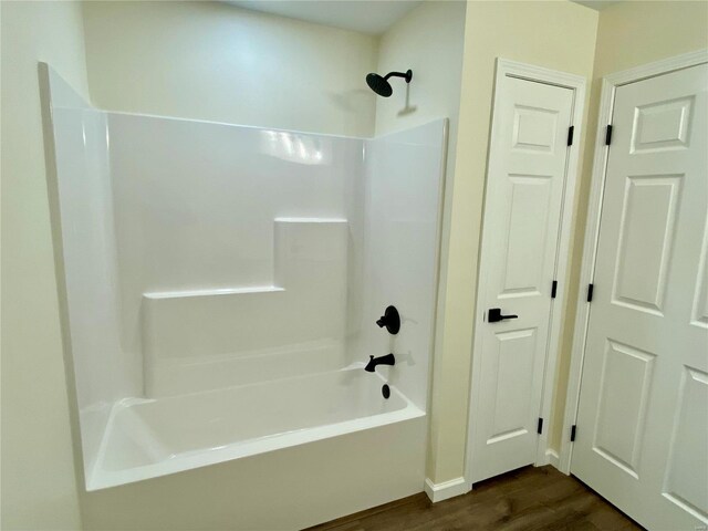 317 E Cypress St, Charleston, MO 63834 - bathroom featuring wood finished floors and bathing tub / shower combination