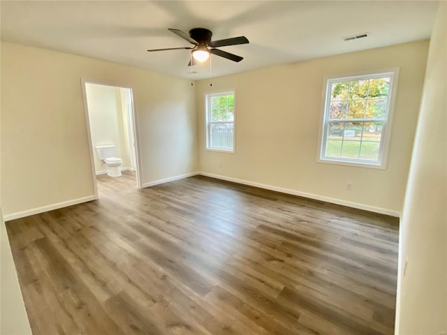 317 E Cypress St, Charleston, MO 63834 - unfurnished room featuring dark wood-style floors, ceiling fan, and baseboards