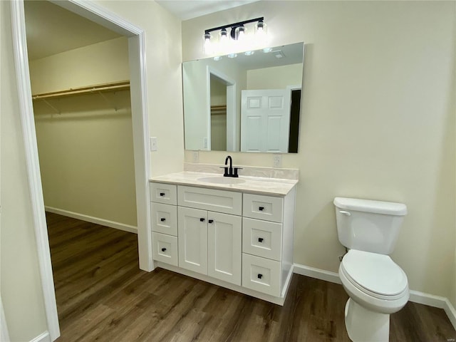 317 E Cypress St, Charleston, MO 63834 - bathroom with wood finished floors, toilet, baseboards, and vanity