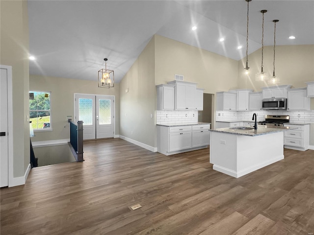 2912 Bluff Ridge Ct, Maryville, IL 62062 - kitchen featuring stainless steel appliances, high vaulted ceiling, a chandelier, a sink, and decorative backsplash