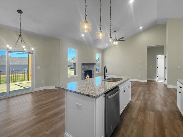 2912 Bluff Ridge Ct, Maryville, IL 62062 - kitchen with a sink, stainless steel dishwasher, open floor plan, a stone fireplace, and dark wood-style flooring