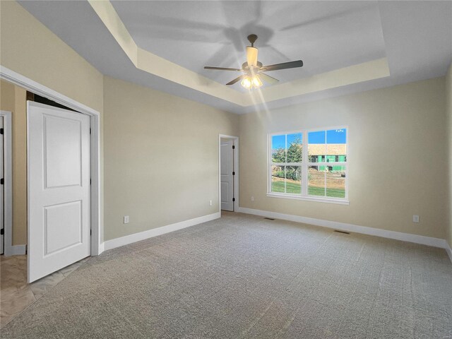 2912 Bluff Ridge Ct, Maryville, IL 62062 - carpeted empty room featuring a tray ceiling, ceiling fan, and baseboards