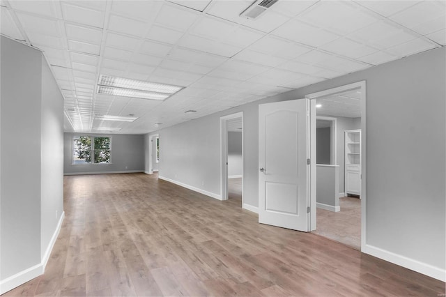 237 Kensington Ln, Cape Girardeau, MO 63701 - empty room featuring wood finished floors, baseboards, and a drop ceiling