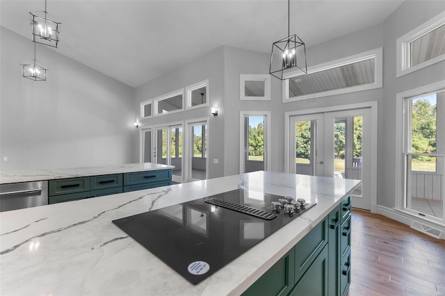 237 Kensington Ln, Cape Girardeau, MO 63701 - kitchen with green cabinetry, french doors, black electric cooktop, a chandelier, and a high ceiling
