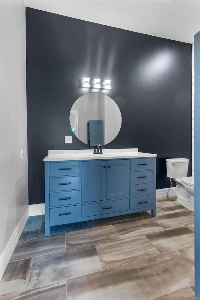 237 Kensington Ln, Cape Girardeau, MO 63701 - bathroom with baseboards, toilet, and vanity