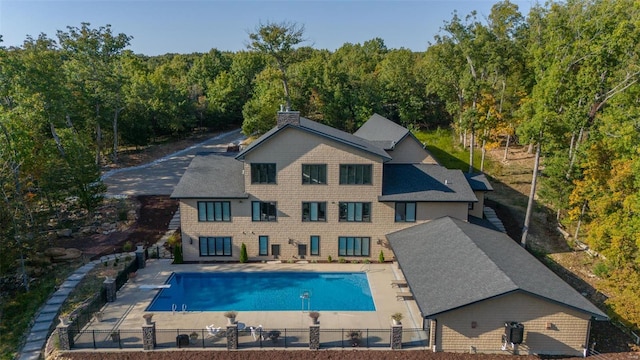 2471 Alpine Cove Dr, Innsbrook, MO 63390 - view of swimming pool featuring fence, a patio area, and a wooded view