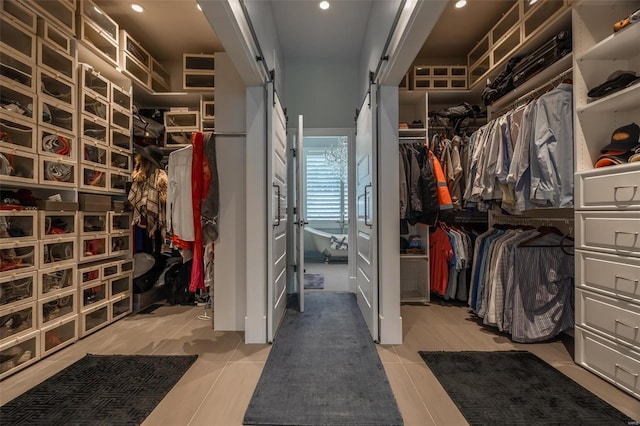 2471 Alpine Cove Dr, Innsbrook, MO 63390 - spacious closet with a barn door and light tile patterned floors