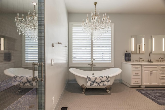2471 Alpine Cove Dr, Innsbrook, MO 63390 - bathroom featuring baseboards, a chandelier, plenty of natural light, and double vanity