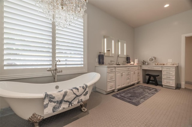 2471 Alpine Cove Dr, Innsbrook, MO 63390 - bathroom featuring a chandelier, vanity, recessed lighting, and a freestanding tub