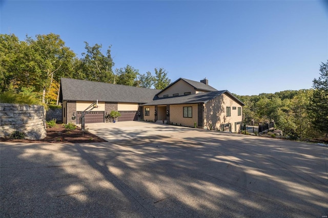 2471 Alpine Cove Dr, Innsbrook, MO 63390 - view of front of property with concrete driveway, a chimney, and brick siding