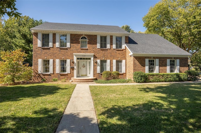 1125 N Franklin St, Litchfield, IL 62056 - colonial house with a front lawn, brick siding, and roof with shingles