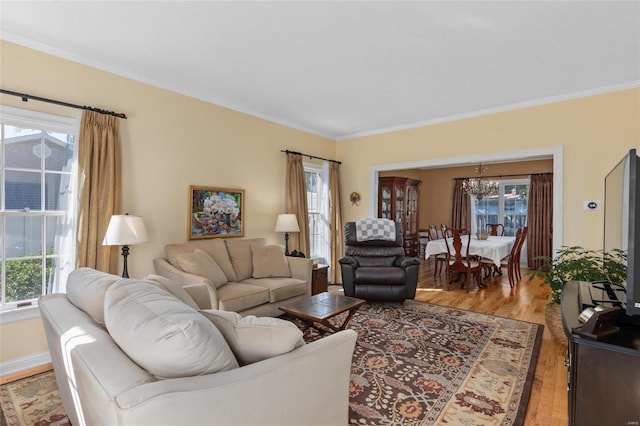 1125 N Franklin St, Litchfield, IL 62056 - living room with a chandelier, crown molding, healthy amount of natural light, and light wood-style floors