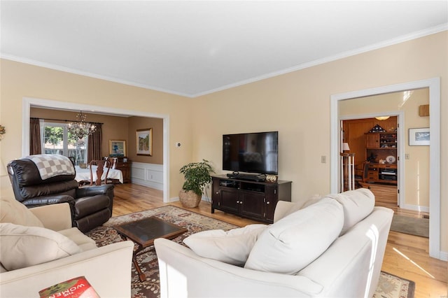 1125 N Franklin St, Litchfield, IL 62056 - living area with light wood-type flooring, a chandelier, ornamental molding, and wainscoting