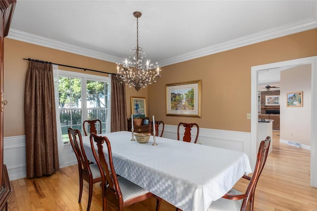 1125 N Franklin St, Litchfield, IL 62056 - dining room featuring a chandelier, crown molding, wainscoting, light wood-style flooring, and a ceiling fan
