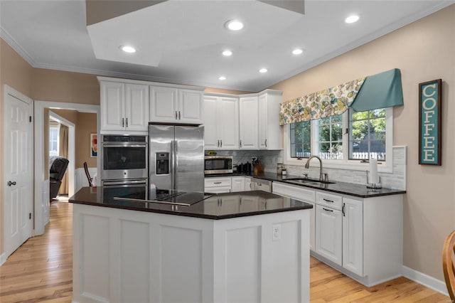 1125 N Franklin St, Litchfield, IL 62056 - kitchen featuring stainless steel appliances, ornamental molding, a sink, white cabinetry, and light wood-type flooring