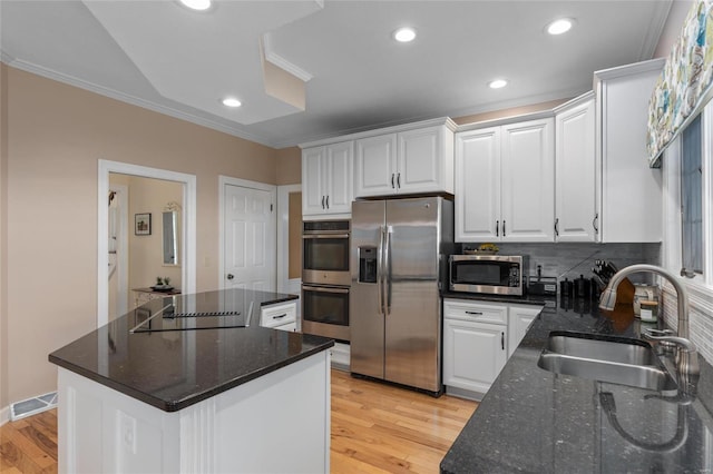 1125 N Franklin St, Litchfield, IL 62056 - kitchen with appliances with stainless steel finishes, a sink, light wood-style floors, white cabinets, and crown molding