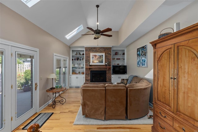 1125 N Franklin St, Litchfield, IL 62056 - living room with a skylight, a ceiling fan, built in features, a brick fireplace, and light wood finished floors